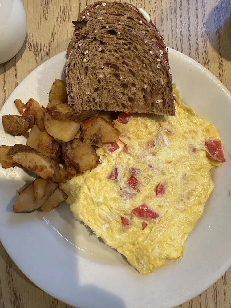Avocado Tomato and Cheddar Omelette with Home Fries and Wheat Toast